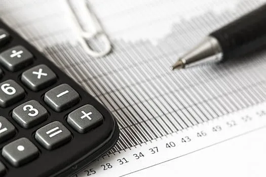 pexels-photo-209224-209224 Close-up of a calculator and pen on a bar graph, representing finance and accounting.